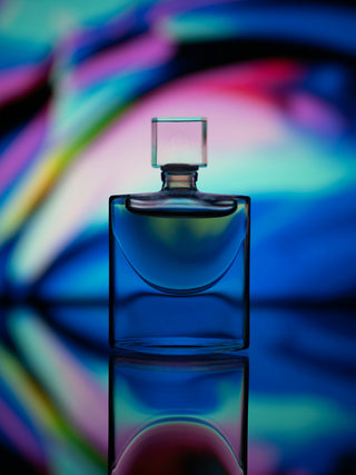 clear glass perfume bottle with pink light