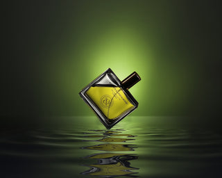 gold colored and black perfume bottle on water