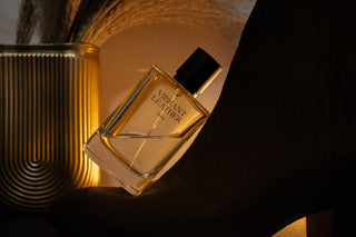 Perfume bottle with elegant gold vase and black accents