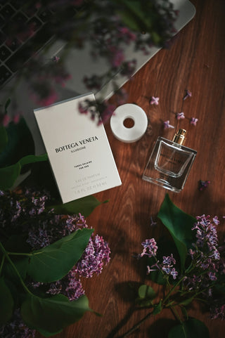 A bottle of bottega veneta perfume with lilac flowers
